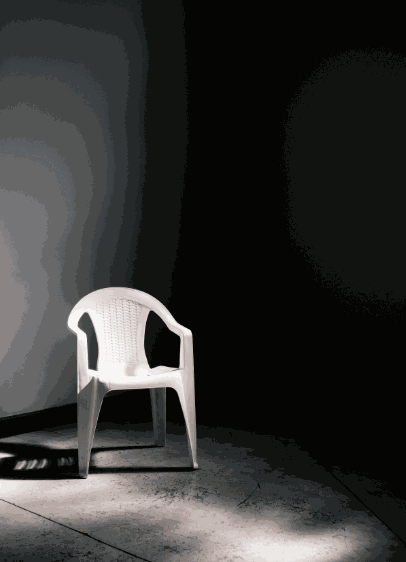 White plastic observation seat in dimly lit corner for workshop attendees