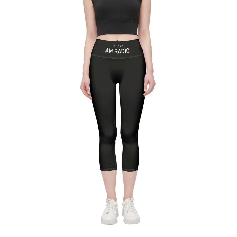 Woman wearing black high-waist AM RADIO Pilates pant with embroidered waistband and cropped length