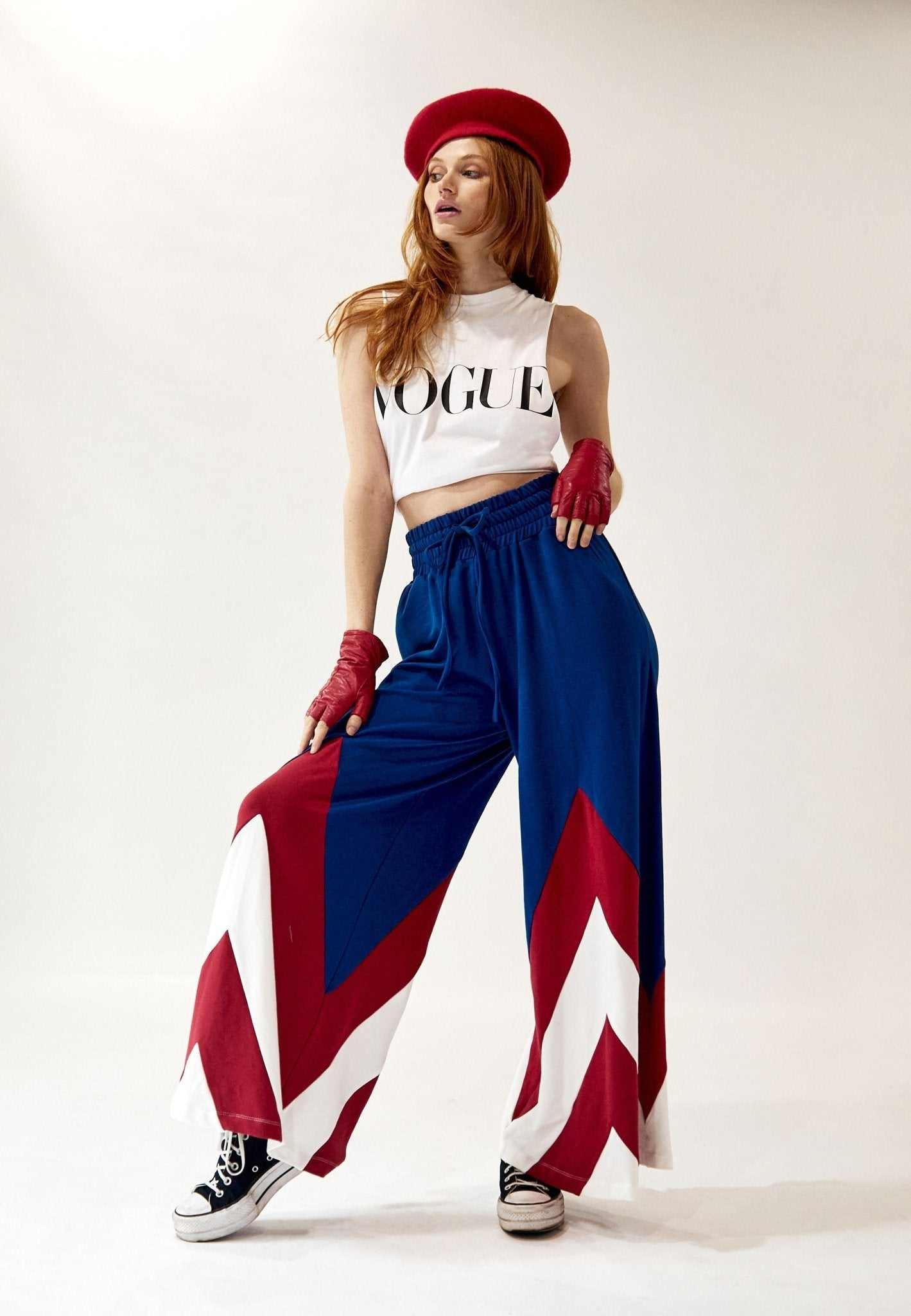 Model wearing AM Wide-Leg Color Block Pant in blue, red, and white with elastic waist and drawstring, styled with cropped white Vogue top and red accessories.