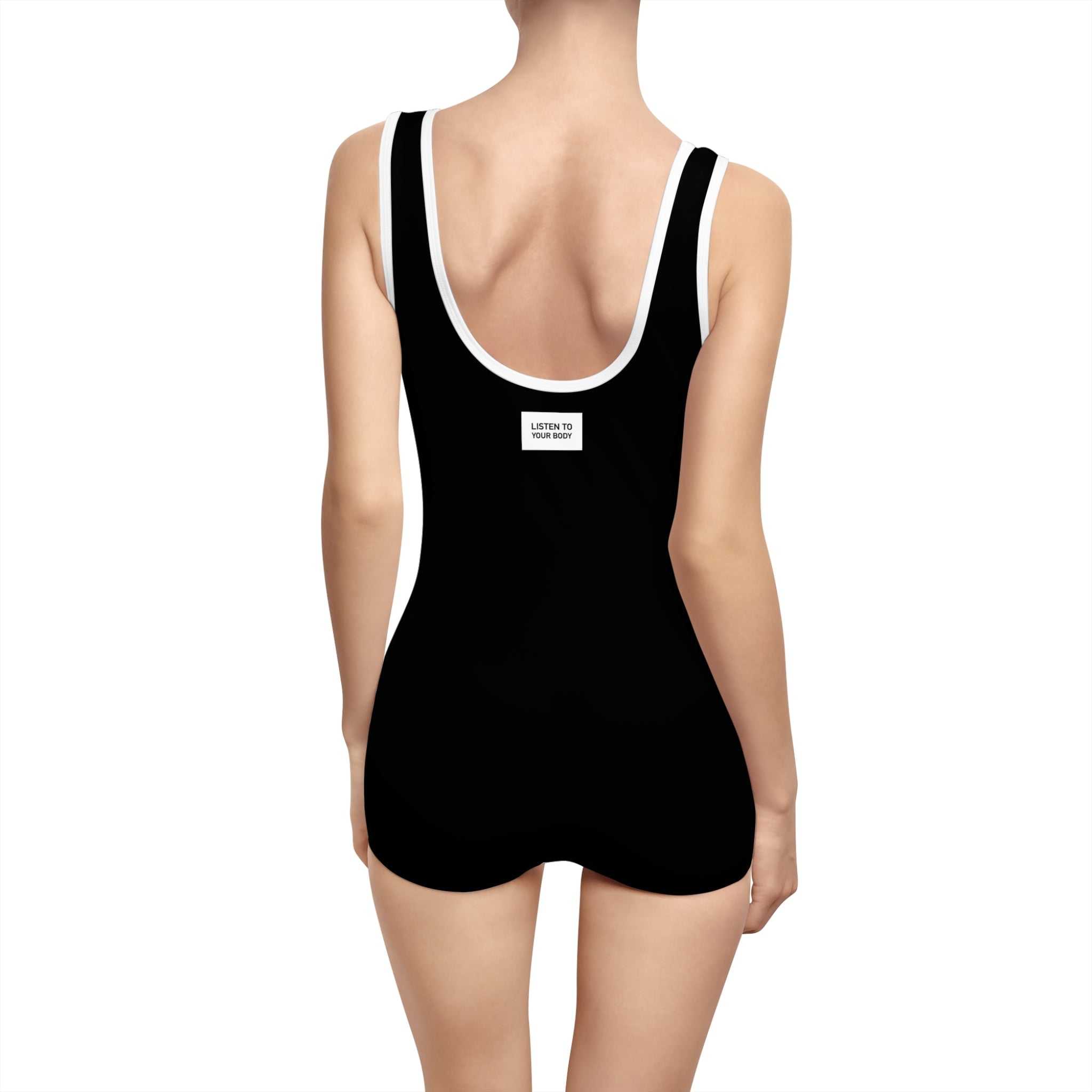 Back view of vintage style black Listen To Your Body Onesie with deep U-shape neck and elastic straps on woman